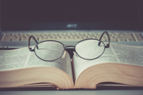 Book with glasses on top